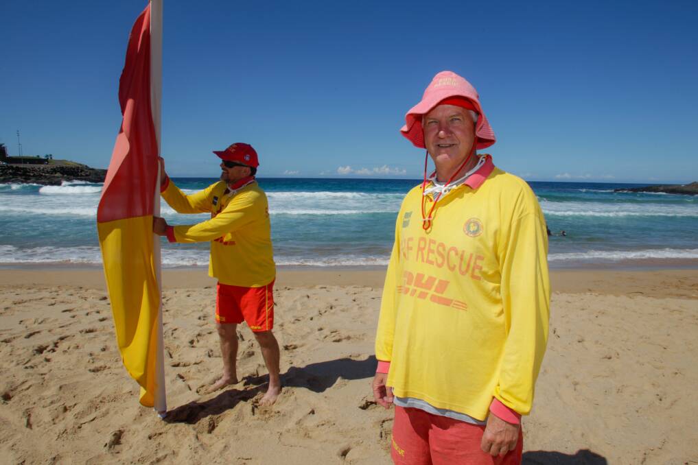 Russel St John and Terry Ogle from Kiama Surf Lifesaving Club putting up the flags on Saturday. Picture: Georgia Matts