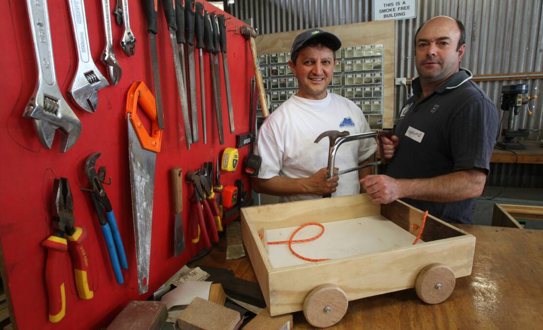 Ramazan Akkoc and Agastinho Moreira at the Coniston Men's Shed in 2012. Picture: Ken Robertson
