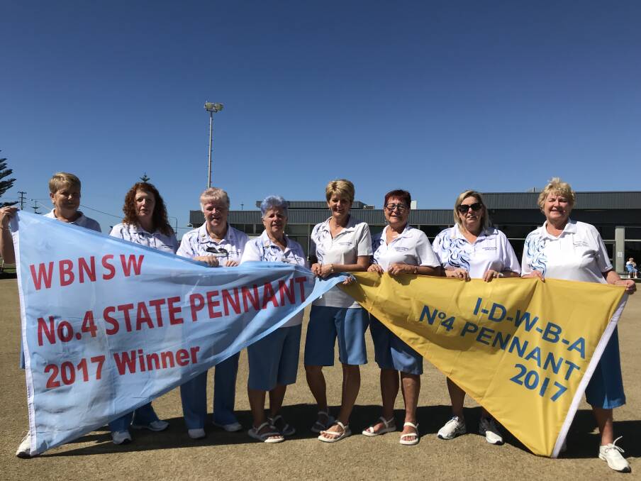 VICTORS: The Windang team unfurl their State Grade 4 pennant flag and District flag following a memorable 2017 season. Picture: Mike Driscoll
