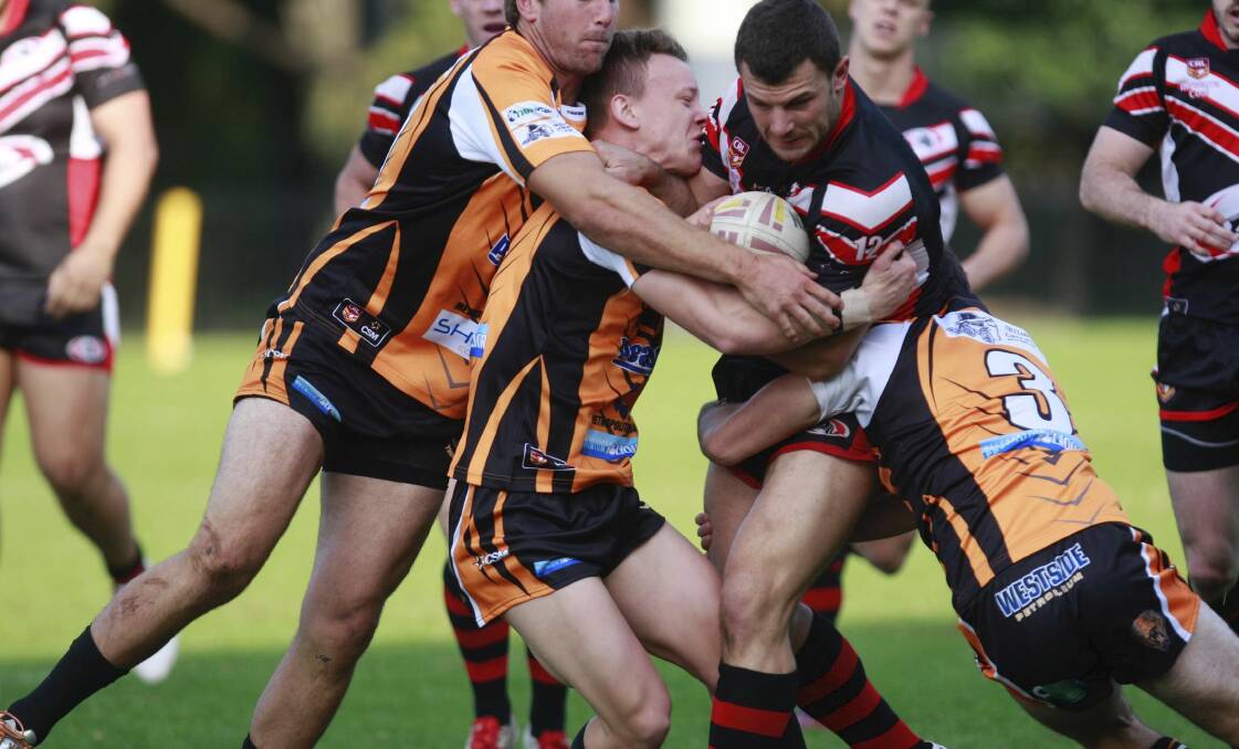 SLUGFEST: Collegians forward Blake Phillips wrestles with the Tigers defence in the Dogs 10-8 win on Saturday. Picture: Georgia Matts