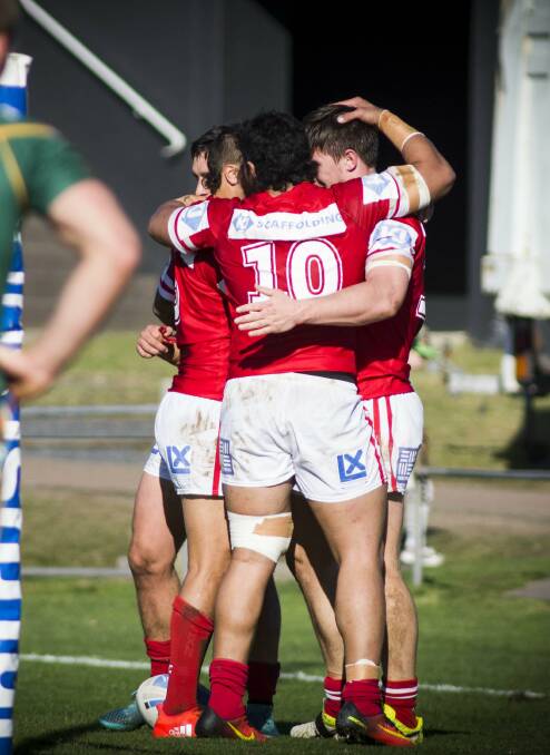 The Cutters celebrate Chris Lewis's second try at Wyong on Saturday.