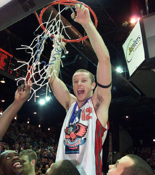 SWEET VICTORY: Hawks skipper Glen Saville cuts down the net after his side delivered the Illawarra faithful their first championship in 2001. Picture: Matt Turner