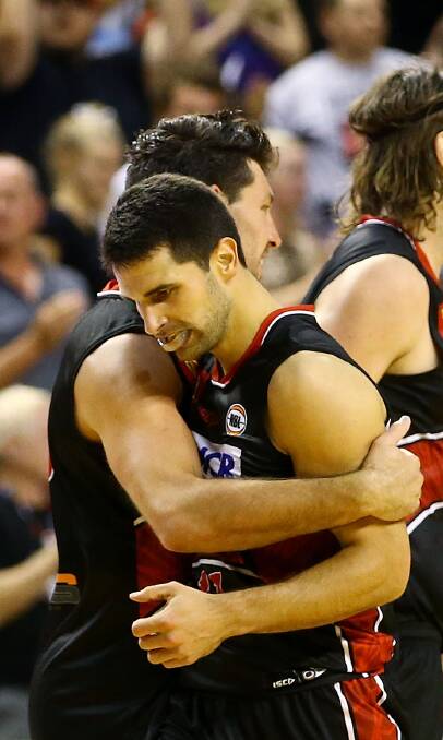 SWEET VICTORY: Illawarra guards Kevin White and Kevin Lisch embrace after the Hawks closed out a tense 96-90 victory over Sydney on Wednesday night.