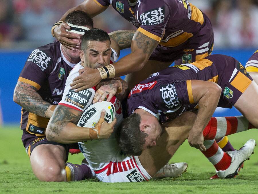 TOUGH STUFF: Paul Vaughan comes to grips with the Broncos defence. Picture: AAP