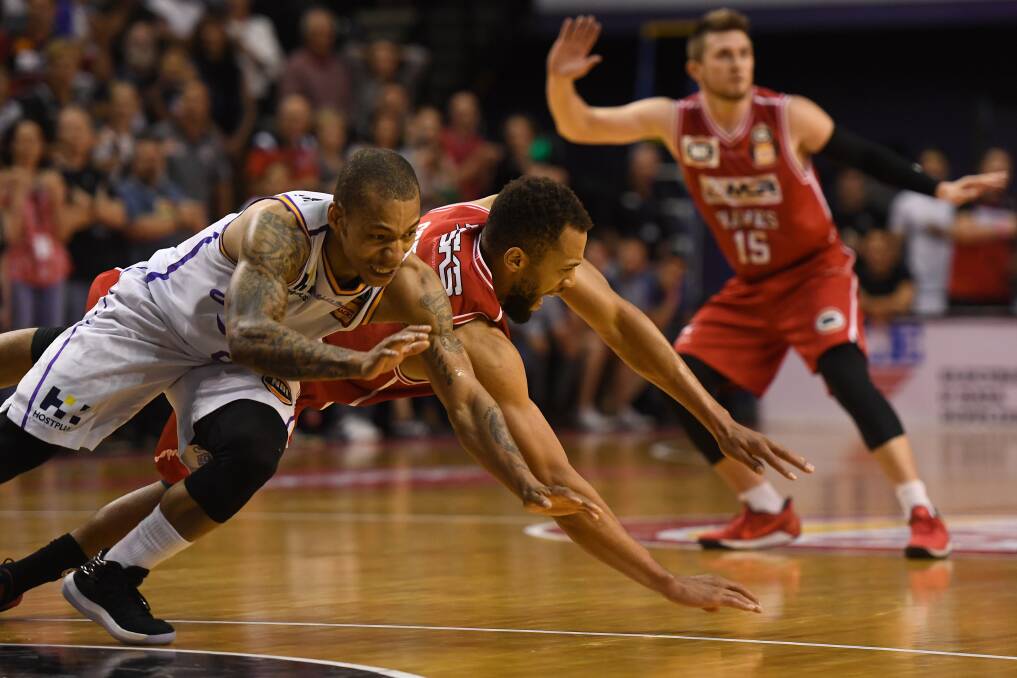 UP FOR THE FIGHT: Illawarra star Demetrius Conger scraps for a loose ball with Sydney Kings import Jerome Randle. Picture: AAP Image