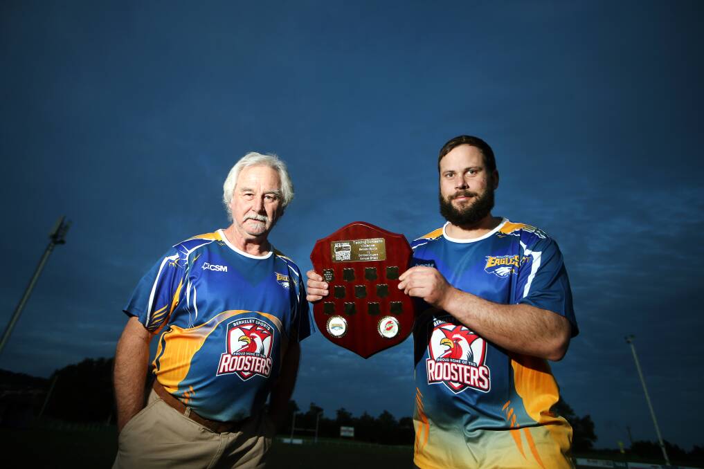 TAKING THE LEAD: Berkeley committee members Howard Burgess and Ben Honan with the Tackling Domestic Violence Shield that will be contested by the Eagles and Corrimal on Saturday. Picture: Sylvia Liber