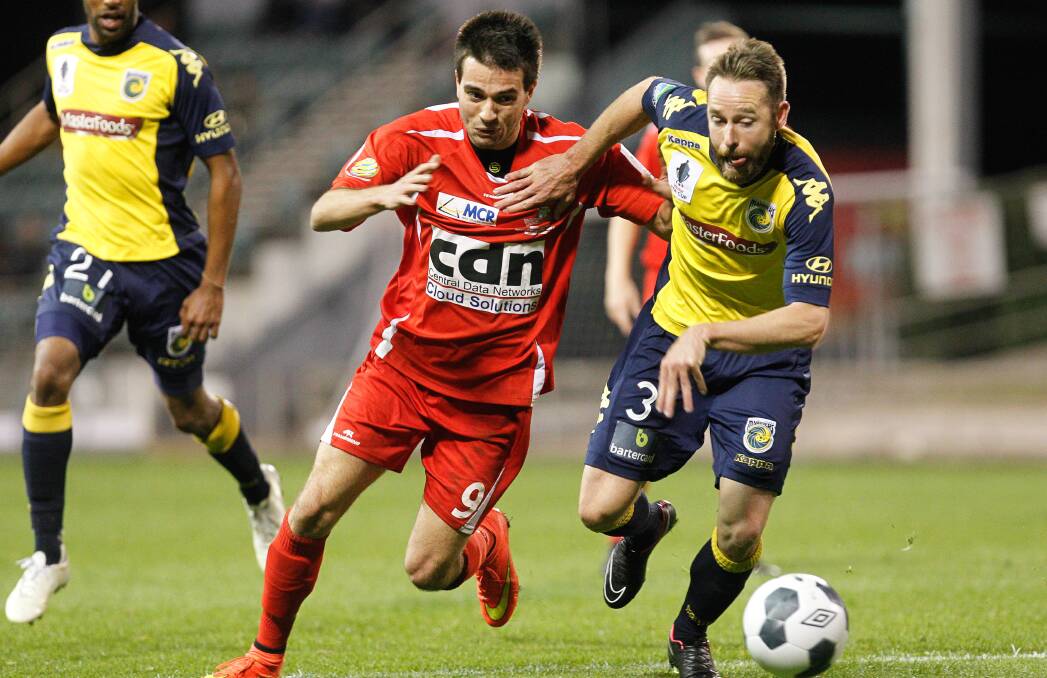 KNOCKOUT: Wollongong's Peter Simonoski challenges for possession the last time the Wolves made the FFA Cup main draw against Central Coast Mariners.