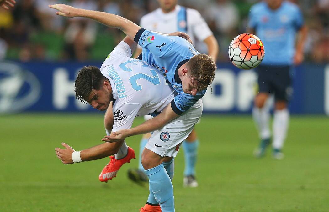 HEAD ON: Helensburgh teenager Aaron Calver battles for possession against Melbourne City star Bruno Fornaroli at the end of last season. Picture: GETTY IMAGES