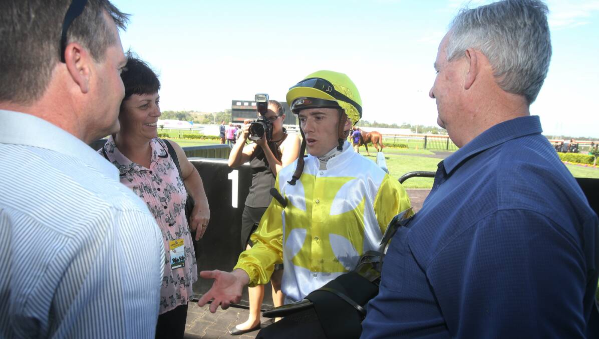 RIDING HIGH: Jay Ford talks to connections after notching up his first winner of the day at Kembla Grange on Saturday. Picture: ROBERT PEET