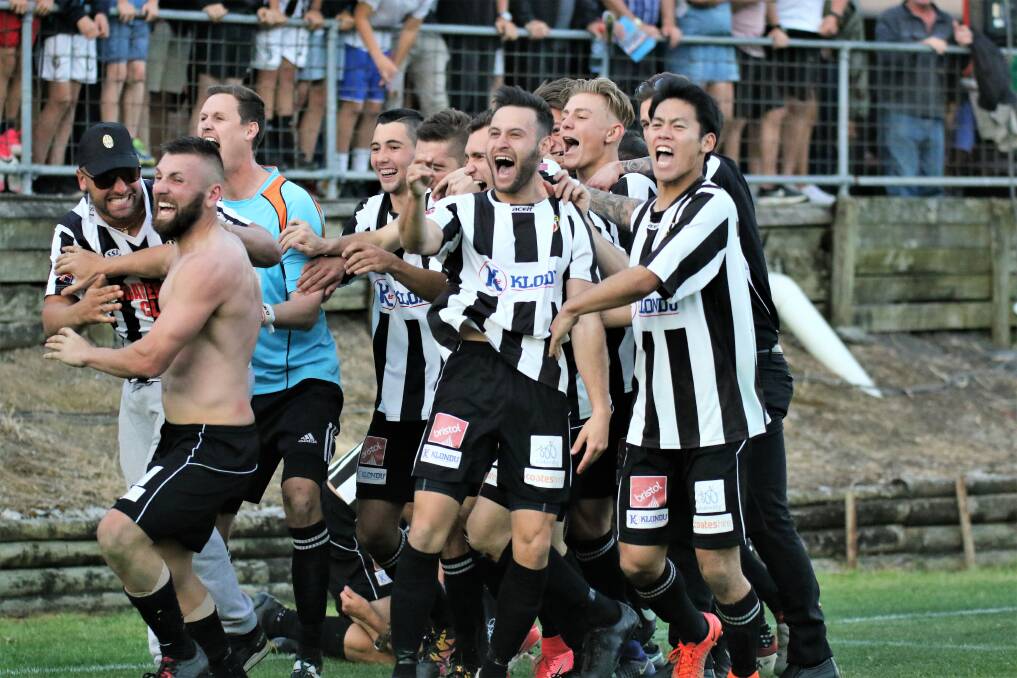 HAPPY DAYS: Port Kembla celebrate with midfielder Ben Zucco after his penalty helped them defeat Bulli. Picture: PEDRO GARCIA