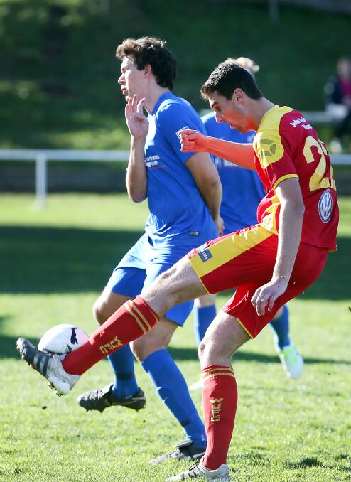 HEARING: Wollongong United's Jackson Brooks clears the ball.