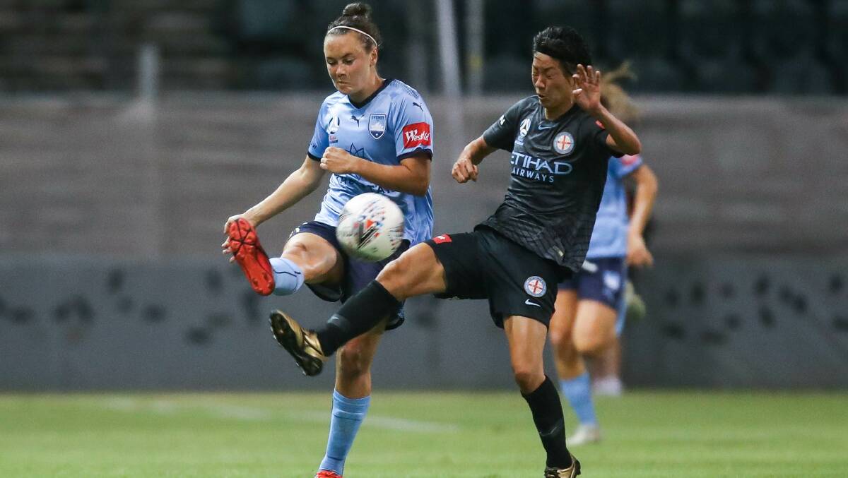 ROUGH NIGHT: Sydney FC star Caitlin Foord battles for possession against Melbourne City goalscorer Yukari Kinga at WIN Stadium. Picture: ADAM McLEAN