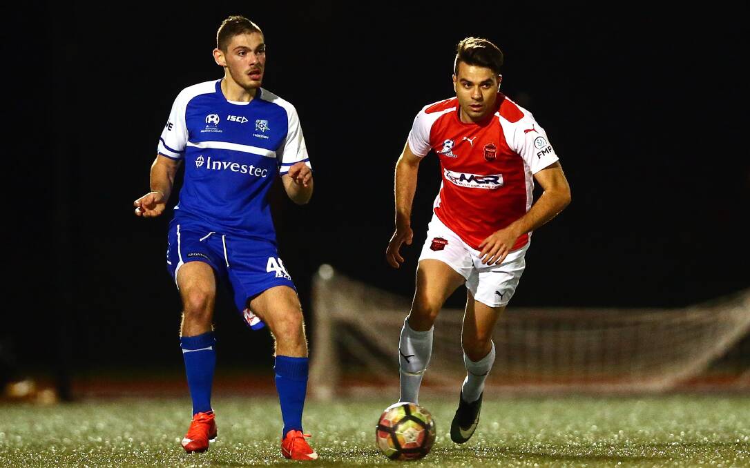 CHASING PACK: Wolves striker Peter Simonoski (red) scored twice to keep Wollongong in touching distance of a finals position. Picture: JEREMY NG/FOOTBALL NSW