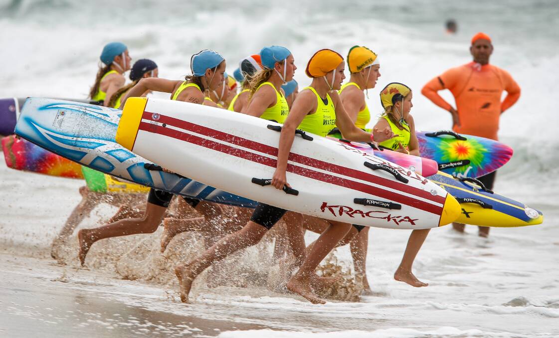 Charge: Junior girls take to the surf during the board event at the Sydney Water series at North Wollongong on Saturday. Picture: Adam McLean