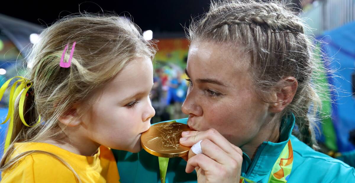 SEALED WITH A KISS: Nicole Beck celebrates winning Rio gold with daughter Sophie. Picture: Getty Images