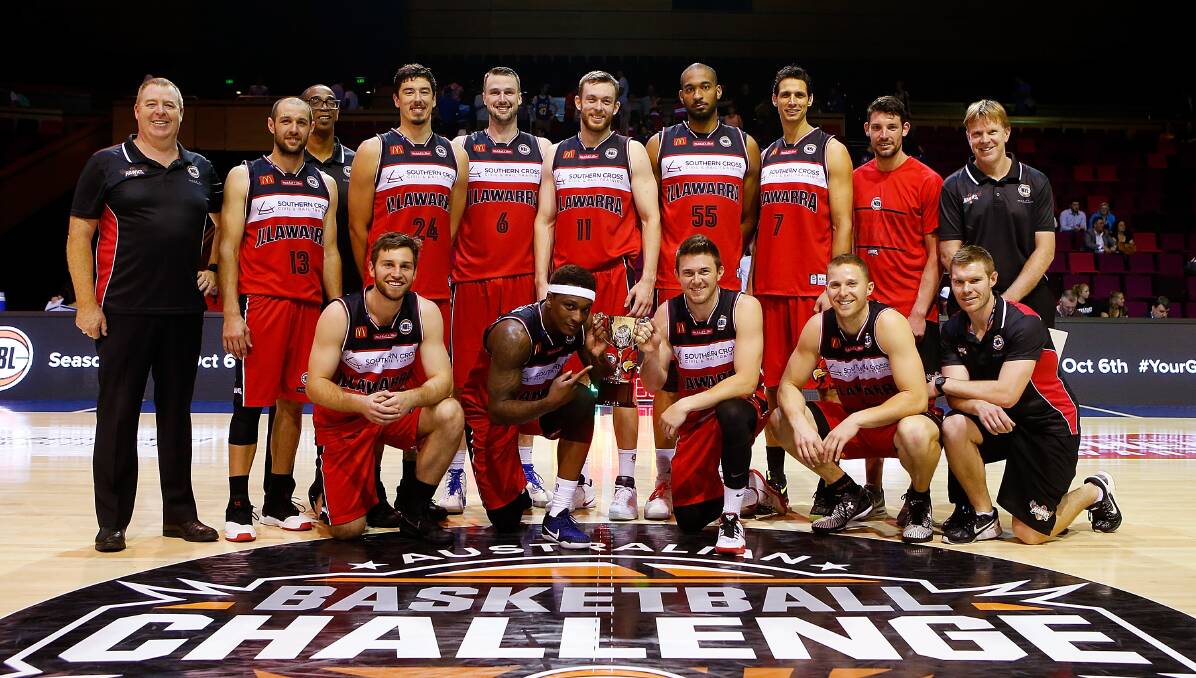 Winning grins: The Illawarra Hawks show off the Australian Basketball Challenge trophy on Monday night. Picture: Getty Images