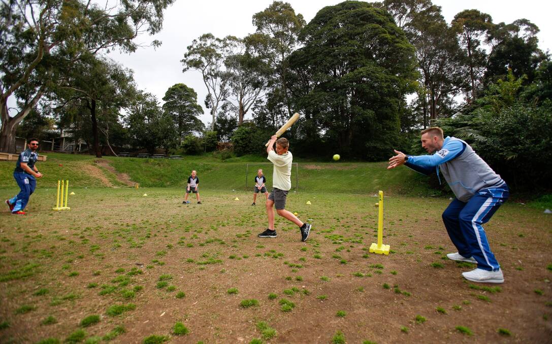 Catch: Ed Cowan and former Test wicketkeeper Peter Nevill with Thirroul's Mason Broadhead. Picture: Adam McLean