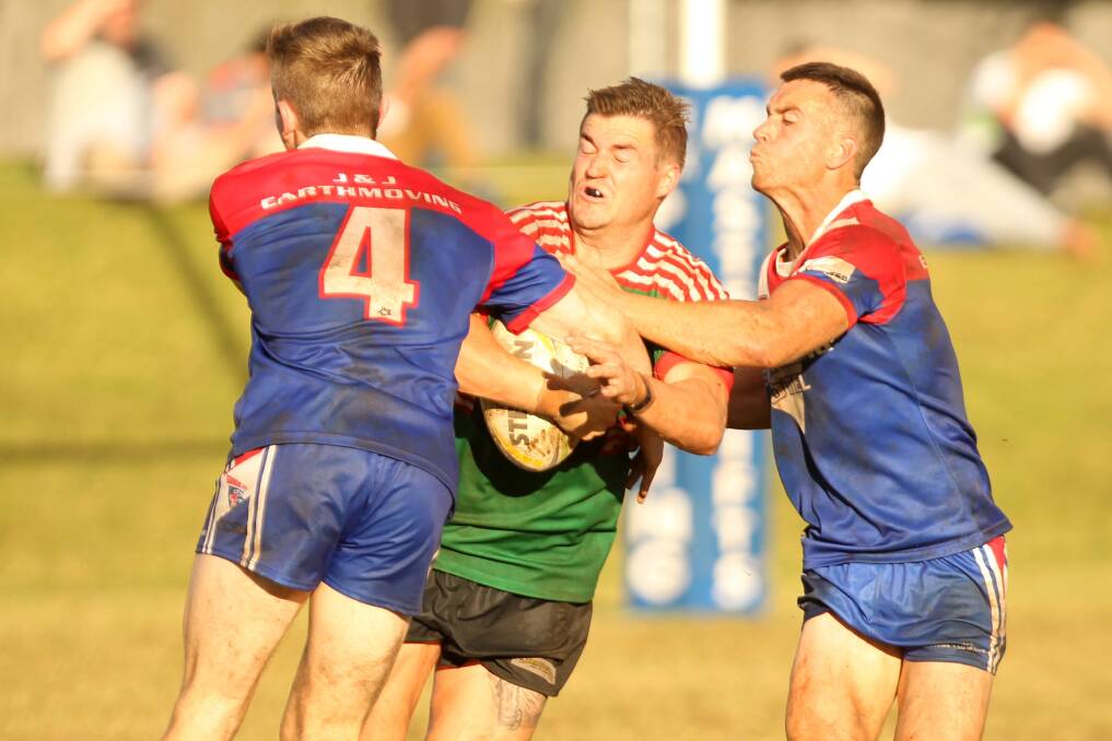 Crunch: Jamberoo's Brandan Smith is tackled by Gerringong duo Toby Gumley-Quine and Rixon Russell. Photo: DAVID HALL