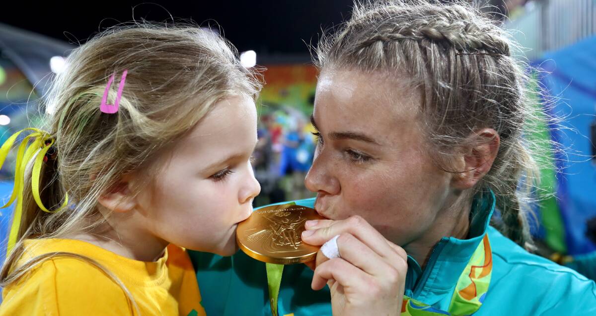 Sealed with a kiss: Bulli's Olympics Rugby Sevens player Nicole Beck with daughter Sophie after winning gold at Rio on Tuesday (AEST). Picture: Getty Images