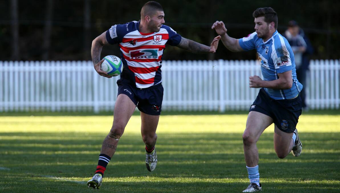 Break free: University's Nick Mastro tries to evade the Vikings defence in Saturday's Illawarra rugby showdown at Uni Oval. Picture: Sylvia Liber