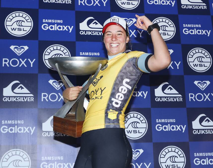 All smiles: South Coast surfer Tyler Wright takes possession of the World Surf League title trophy in France. Picture: Kelly Cestari/WSL