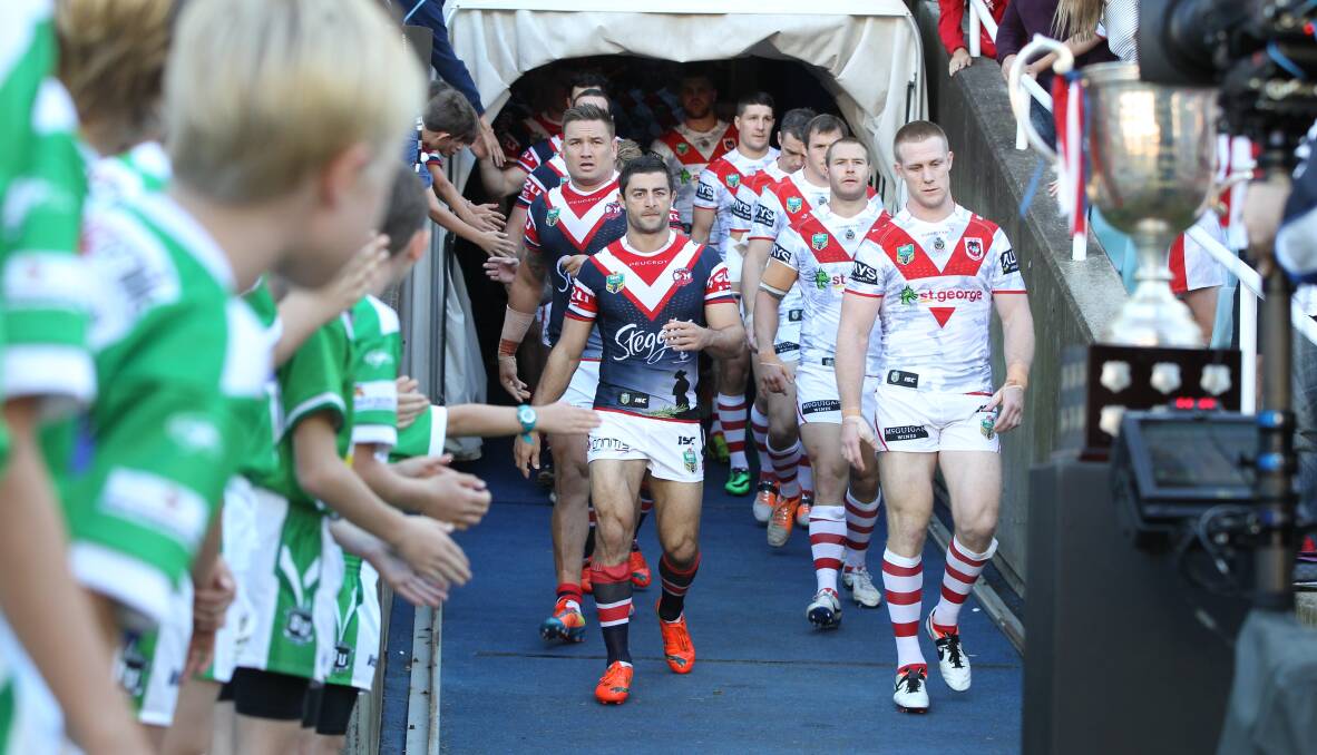 Honour: Dragons captain Ben Creagh (right) and Roosters fullback Anthony Minichiello lead the players out in the 2014 Anzac Day clash at Allianz Stadium. The rivalry is renewed on Monday. Picture: Anthony Johnson