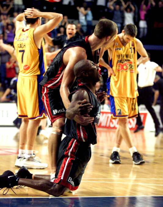 Fate: Damon Lowery sinks to his knees as his free throw puts the Hawks into the 2001 NBL grand final series. Picture: Robert Peet