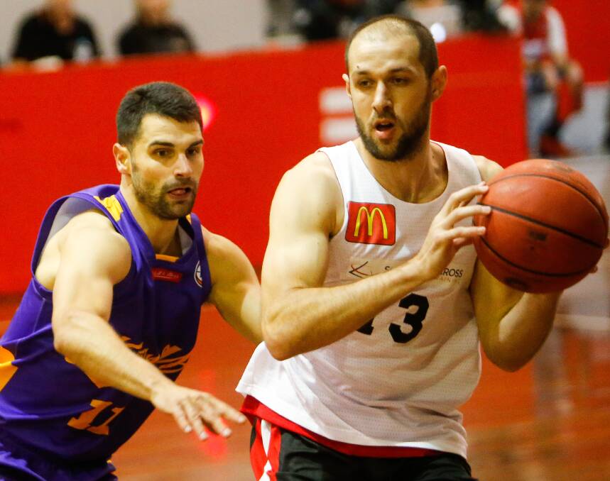 BATTLE AHEAD: Former Hawks MVP Kevin Lisch takes on Rhys Martin in a pre-season game at the Snakepit. Picture: Adam McLean