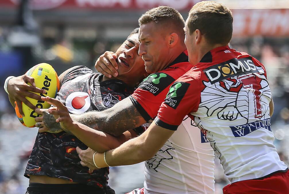 CAUGHT: Tariq Sims and Kurt Mann tackle Warriors player Ata Hingano at the Auckland Nines. 