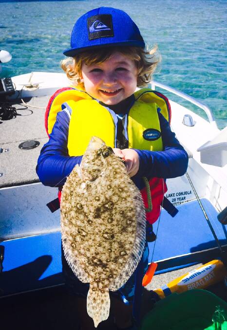 What a catch: Three-year-old Sam Tubridy is all smiles holding a flounder during a recent trip on the lake. 