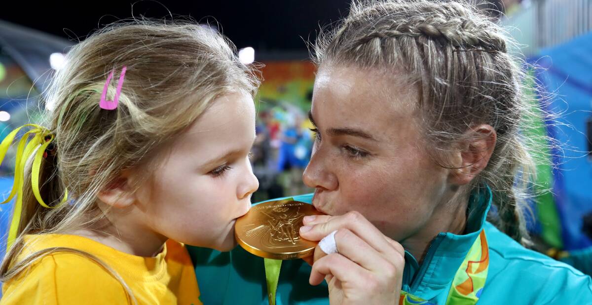 Sealed with a kiss: Bulli's Nicole Beck celebrates winning gold in the Rio rugby sevens tournament with daughter Sophie. Picture: Getty Images