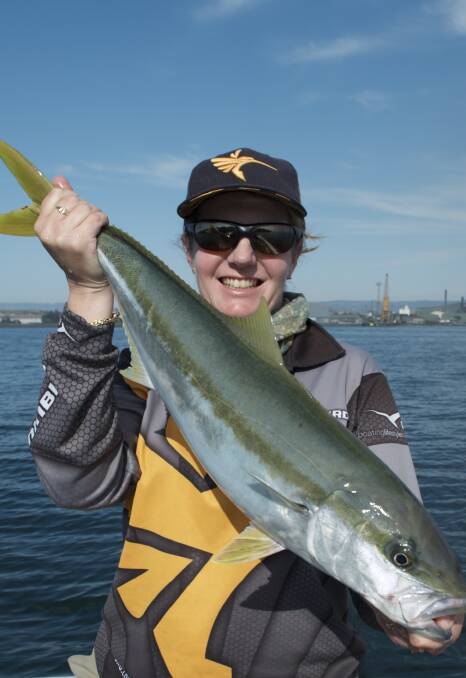 Queen of kings: With the steelworks in the background, Vicki Lear shows off a solid Port islands kingfish catch from last weekend.
