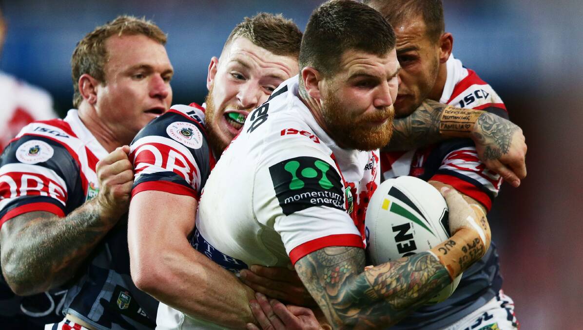 Caught: Josh Dugan is tackled by the Roosters during St George Illawarra's Anzac Day win at Allianz Stadium. Picture: Getty Images