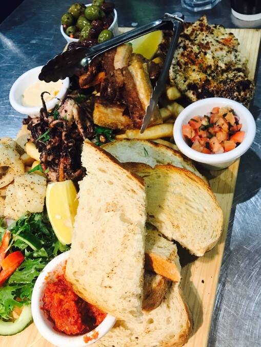 Delicious: The King G platter - garlic olives, tomatoes brush, grilled chorizo, Greek chicken, squid, pork belly, baby octopus, haloumi, chips and salad.