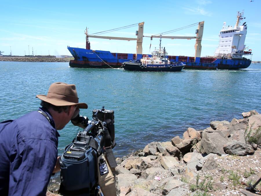 COMING HOME: Laden with tonnes of nuclear waste, the BBC Shanghai moves across Port Kembla's outer harbour. Picture: Robert Peet