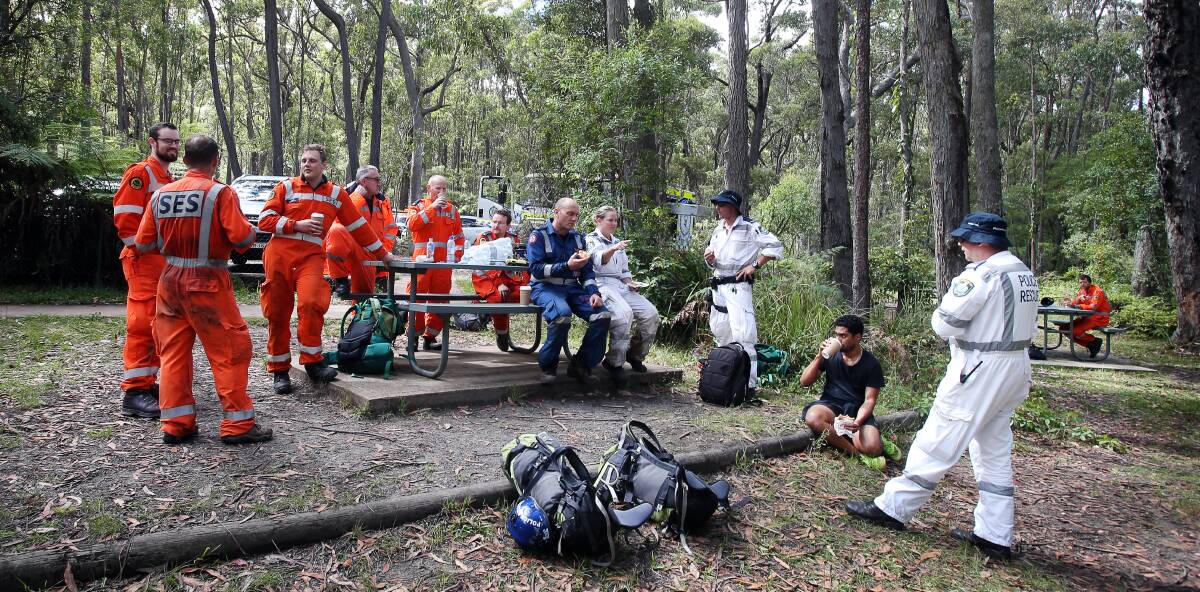 SUCCESS: Rescue crews debrief and refuel after emerging from the bush at Carrington Falls on Tuesday morning. Picture: Sylvia Liber