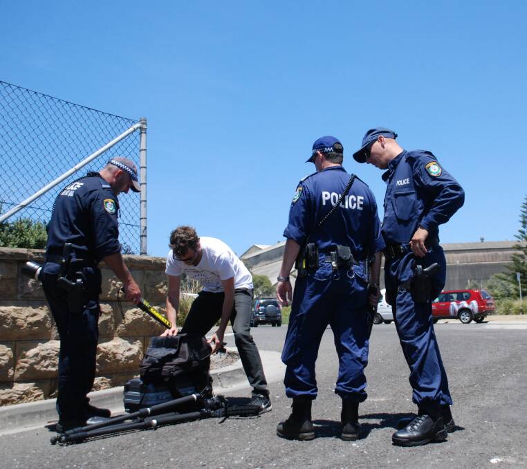 PRECAUTIONS: Police scan the equipment of a Greenpeace photographer granted entry to the port's southern breakwall. Picture: Angela Thompson 