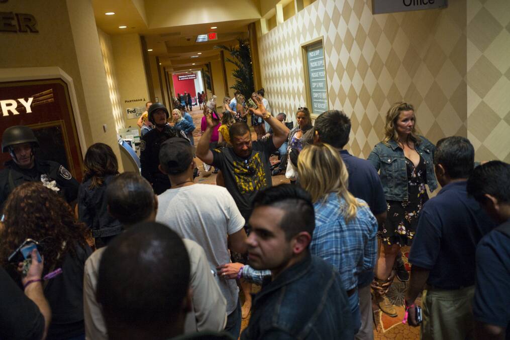Casino patrons are searched by Las Vegas police. Photo: Chase Stevens, AP