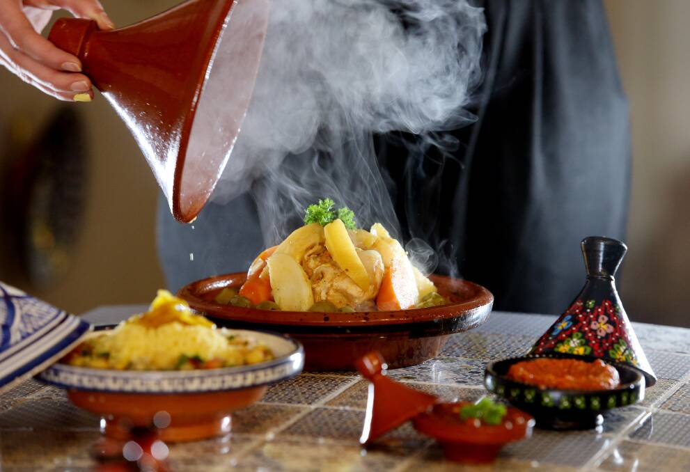 Steam fills the air as the lid is lifted on Casablanca's chicken tagine. Picture: Robert Peet