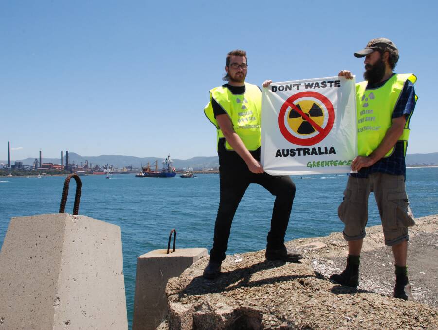UNSAFE: Greenpeace protesters James Mather and Daniel Jones witness the shipment's arrival from the harbour's southern breakwall. Picture: Angela Thompson