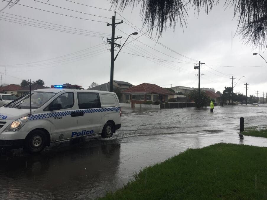 Flood waters submerge the roadway at the corner of Swan and Evans streets, Wollongong. Picture: Adam McLean