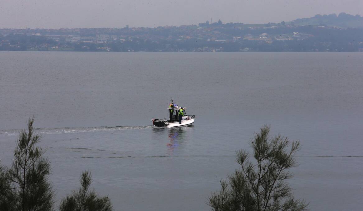 FALSE ALARM: A Marine Rescue boat retreats from Hooka Creek Point Monday morning after crew investigated a report of a washed-up body. Picture: Robert Peet