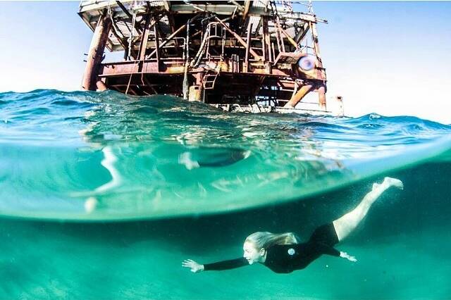 A surfer explores the surrounds of the defunct Oceanlinx Wave Generator. Picture: Georgia Matts