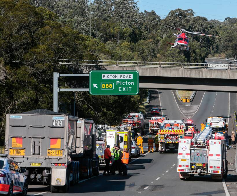 EMERGENCY: A rescue chopper prepares to land on the M1, Wednesday morning. 