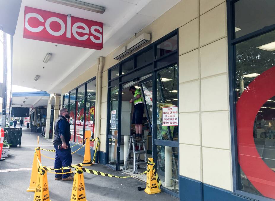 DESTRUCTION: Tradesmen make repairs to the Walker Street entrance, Wednesday afternoon. Picture: Sylvia Liber