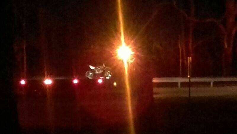 A trail bike involved in a crash at Dapto in the early hours of Sunday morning is removed from the Princes Highway. Picture: supplied