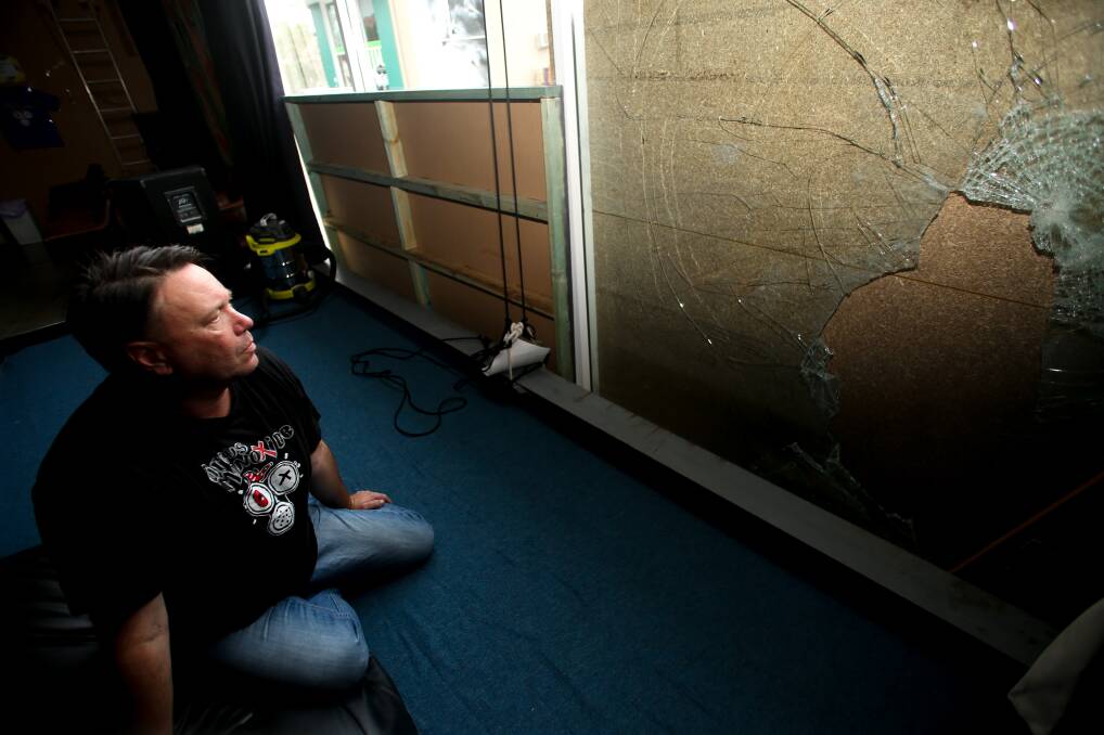 NOT WORTH IT: Jonathan Christley inspects damage to Circus Monoxide's Fairy Meadow headquarters. Picture: Georgia Matts