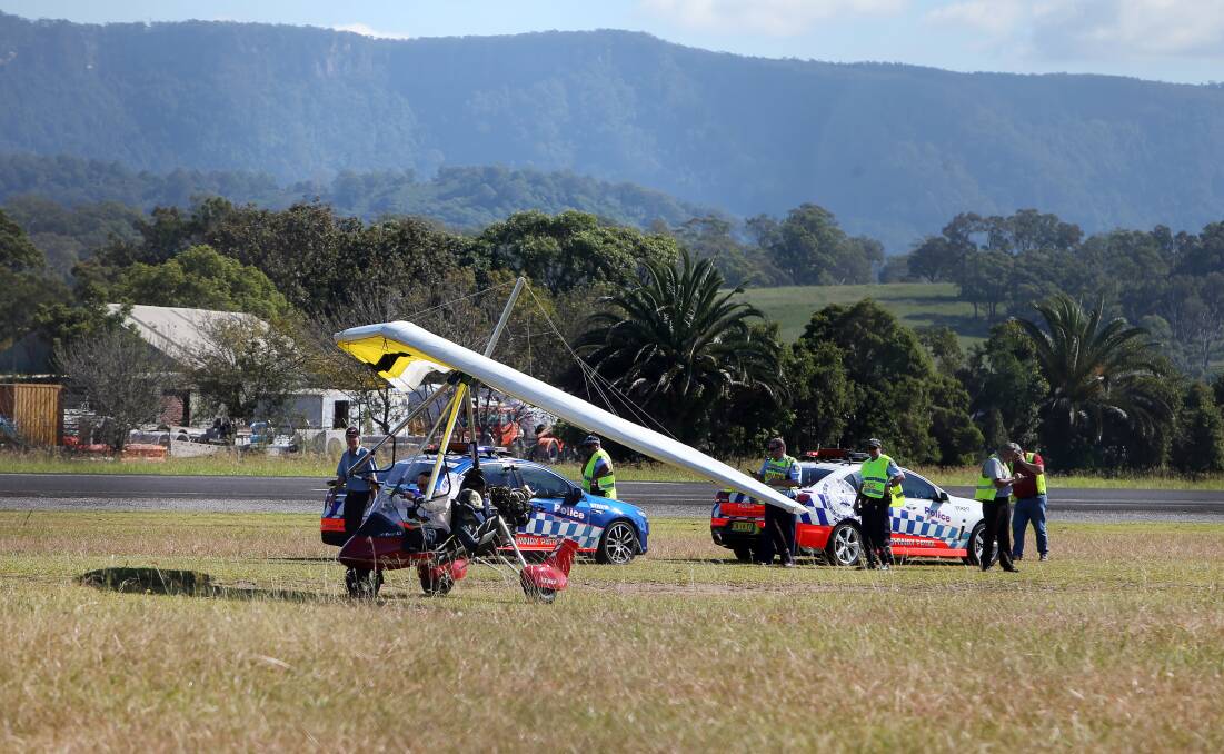 ALL LIGHT: Responding police officers look on as the recovered microlight departs the site of the accident. Picture: SYLVIA LIBER