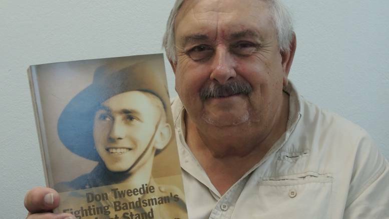 Terry Tweedie with his newly published book on father Don, prisoner of war, father of five and member of Forbes Town Band from 1962 to 2007.