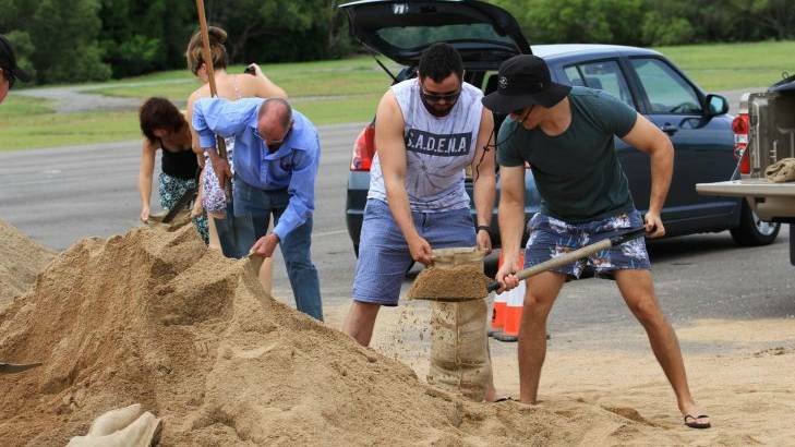 Huge piles of sand were dumped at Lou Lister Park for local residents to dig into with shovels and sandbags. Photo: Jorge Branco